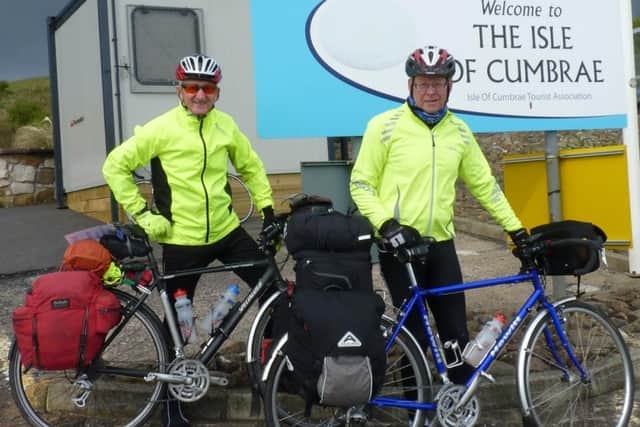 Bill Honeywell (right) and Richard Dugdale arrive at the Isle of Cumbrae, in the Firth of Clyde, during their four-week charity cycle tour of the Western Isles.