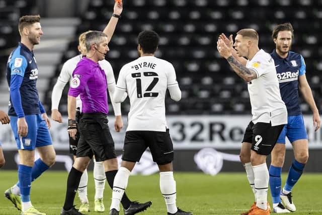 Referee Darren Bond shows the red card to Derby striker Martyn Waghorn for a foul on PNE's Alan Browne