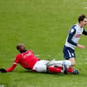 Preston North End midfielder Tom Bayliss is challenged by Nottingham Forest's Samba Sow at Deepdale