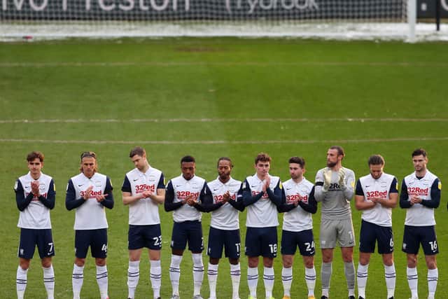 Tom Bayliss, far left, takes part in the minute's applause in memory of former PNE player and manager Tommy Docherty