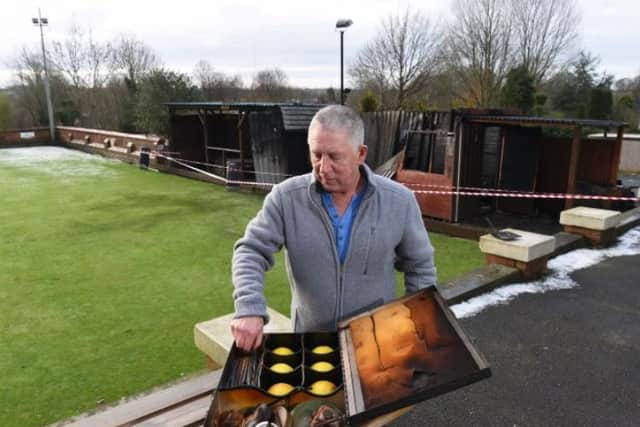 Committee member Martin Hill examines the charred remains of bowling equipment.
