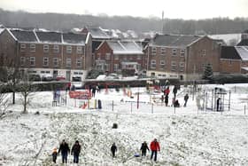 Families enjoy the snow in Buckshaw Village, near Chorley, earlier this week. North West Ambulance Service is urging people to be careful in the ice and snow after a recent spike in calls to the service