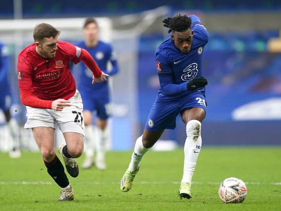 Morecambe's Ryan Cooney (left) and Chelsea's Callum Hudson-Odoi (right) battle for the ball during the Emirates FA Cup third round match at Stamford Bridge