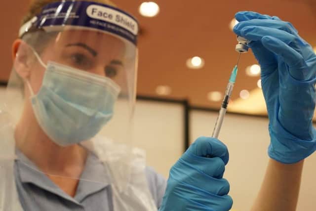 A healthcare professional prepares a dose of Covid-19 vaccine