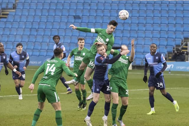 PNE's Andrew Hughes challenges in the box against Wycombe