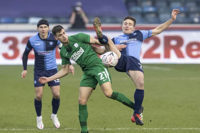 PNE new boy Jayson Molumby challenges Wycombe's David Wheeler