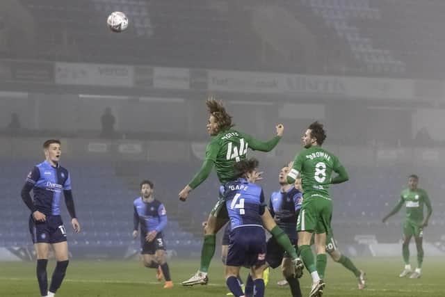 North End midfielder Brad Potts sends a header too high in the defeat to Wycombe