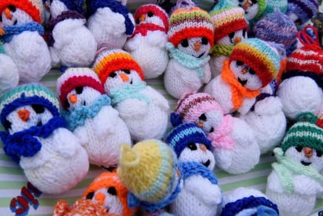This is Linda's sixth year knitting festive snowmen
