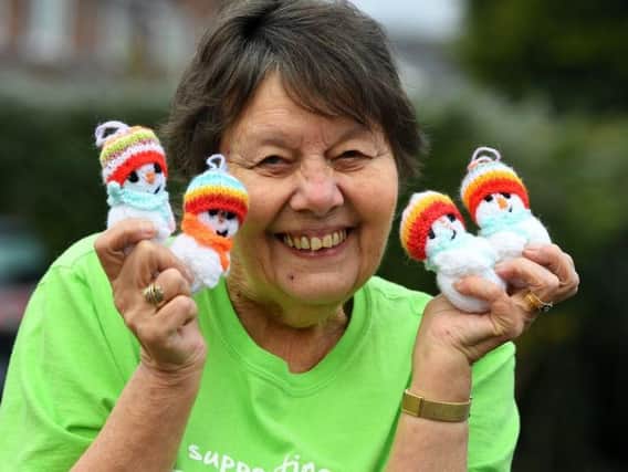 Linda has knitted and sold 420 snowmen to raise money for the hospice