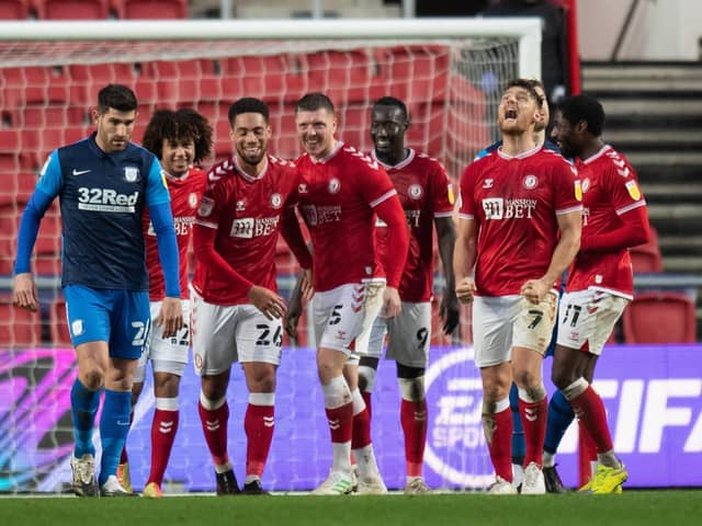 Bristol City’s Zak Vyner (No.26) celebrates scoring his side’s second goal as PNE’s Ched Evans (left) looks downcast