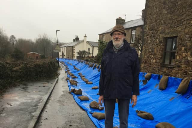 Mr Brian Woodward  pictured by the flood defences installed on Greenside, Ribchester