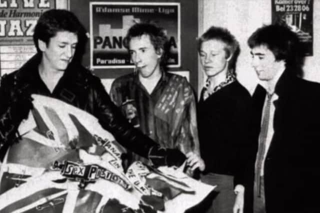 The Pistols tearing up an EMI poster after splitting with their record company in the wake of the disastrous tour.