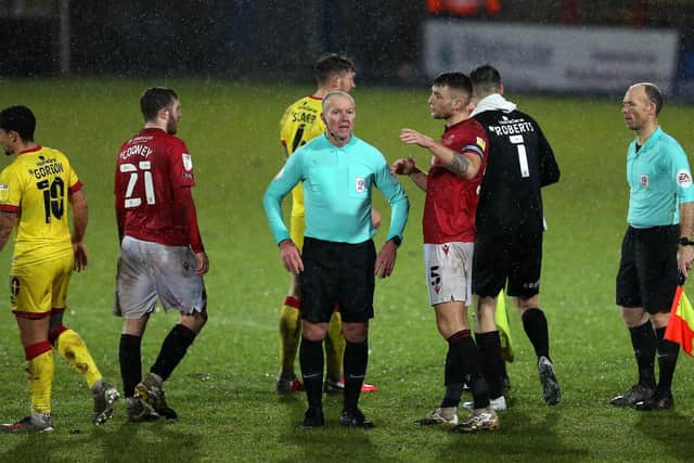 Morecambe skipper Sam Lavelle talks to referee Graham Salisbury during Tuesday's draw with Walsall