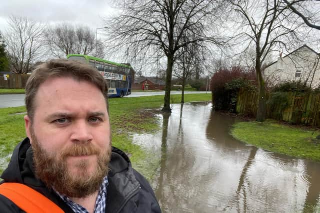 Councillor John Potter by the flooded pathway that he claims is 'dangerous'