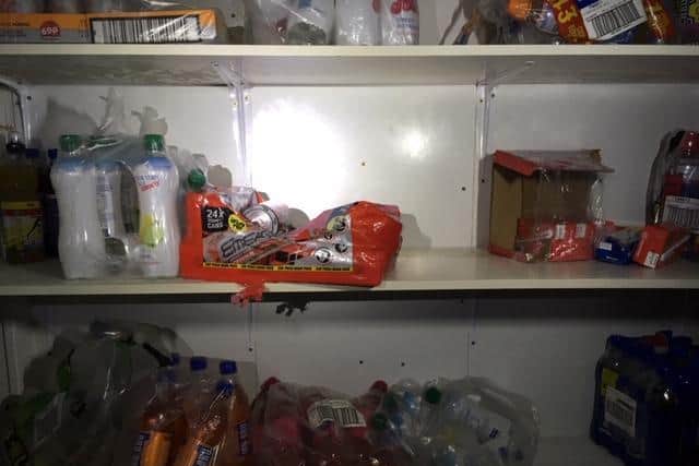 The compartment was disguised in this ordinary looking shelving unit