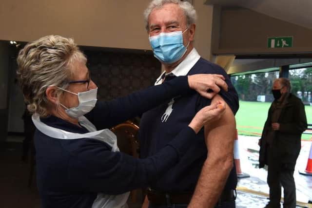 75-year-old John Dent receiving his first dose of the Covid-19 vaccine
