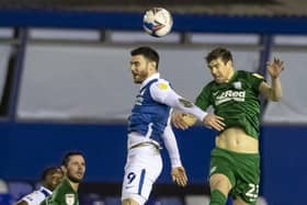 Preston North End defender Paul Huntington jumps with Birmingham striker Scott Hogan on his 300th PNE appearance
