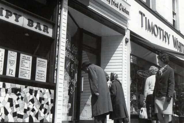 Potential customers gaze through the window of the country’s first Kentucky Fried Chicken ‘Take Home Shop’ which opened in Fishergate, Preston, in May 1965