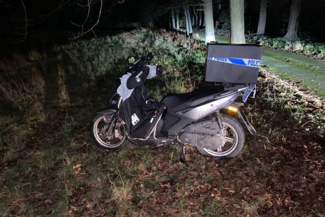 The scooter belonging to a delivery rider who was knocked from it by a falling branch