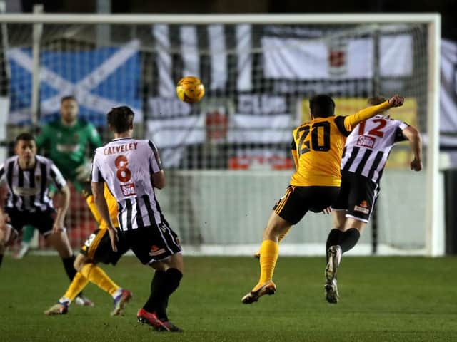Vitor Ferreira fires a long range effort past Matty Urwin to give Wolves the lead in the 12th minute
