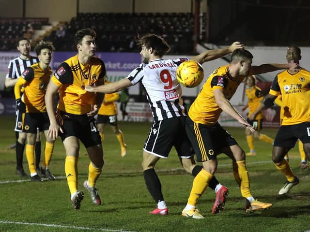 Harry Cardwell in the thick of the action for Chorley against Wolves