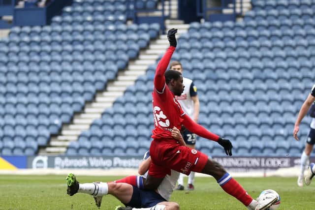Reading striker Lucas Joao is wrestled to the floor by Preston North End left-back Joe Rafferty for the Royals' penalty