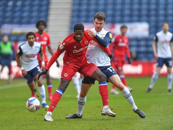 Preston North End's Ben Whiteman battles with Reading's Lucas Joao