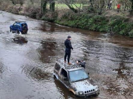 Police have shared this picture of two 4X4s "playing" in the ford across Wyre Lane, Garstang, with one appearing stuck and in need of rescue