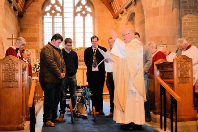 Pastoral role - Canon Ron blesses the plough,urn, seeds and spade watched by members of Bilsborrow Young Farmers