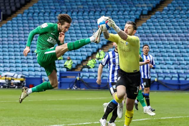 North End skipper Alan Browne challenges with Sheffield Wednesday goalkeeper Keiran Westwood