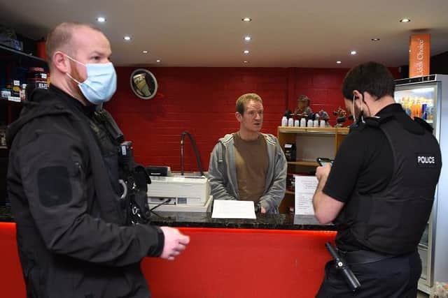 Officers talk to Steven Todd, owner of Reps Gym
