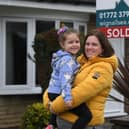 Sarah Ainscow and daughter Evie outside their Leyland home.