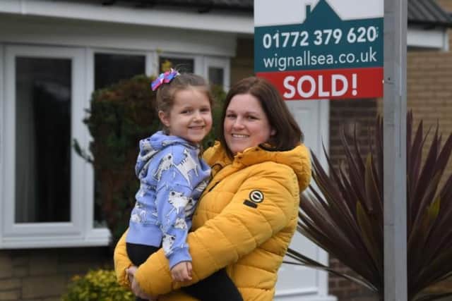 Sarah Ainscow and daughter Evie outside their Leyland home.