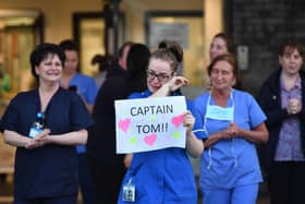 A nurse at Aintree University Hospital sheds a tear and as she pays tribute to super fundraiser Captain Tom Moore during the "Clap for Our Carers" and the NHS on April 16, 2020