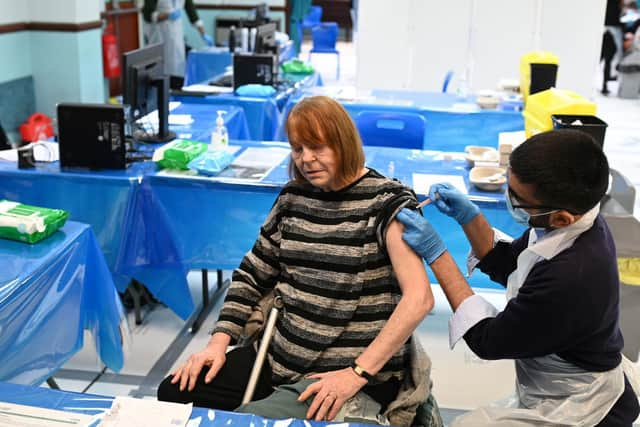 Pharmacist, Minhal Master administers a dose of the AstraZeneca/Oxford Covid-19 vaccine at a temporary vaccination centre