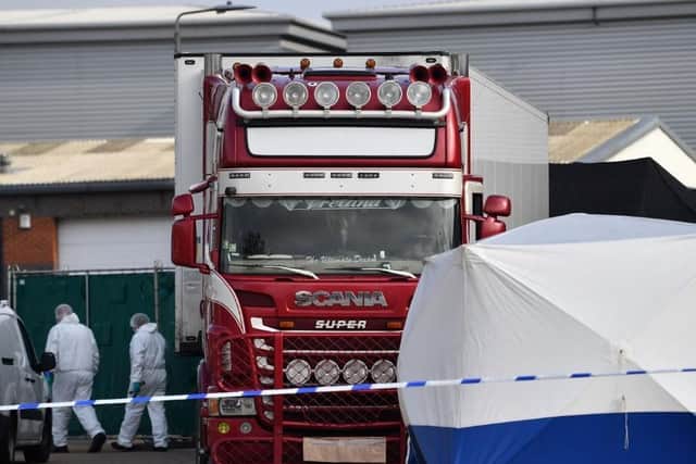 Police officers in forensic suits in Essex with a lorry, in which 39 people died while being trafficked (Picture: Ben Stansall/AFP via Getty Images)