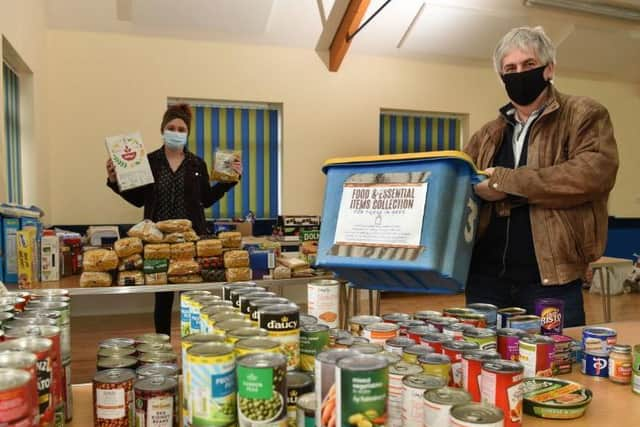 Volunteers from the local community sort through donations at the community centre