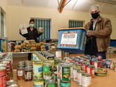 Volunteers from the local community sort through donations at the community centre