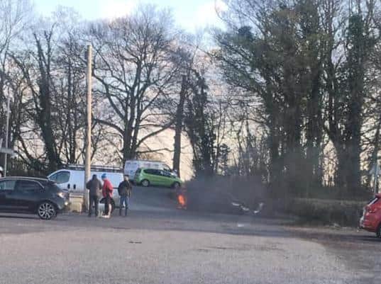 The BMW shrouded in thick black smoke. Lancashire Fire and Rescue Service said the cause is under joint investigation with Lancashire Police. Pic: Dalziel Eccleston