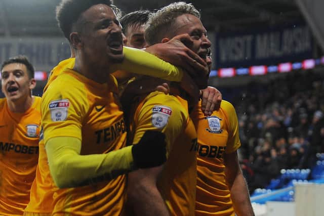 Tom Clarke and Callum Robinson celebrate, with Jordan Hugill about to join.