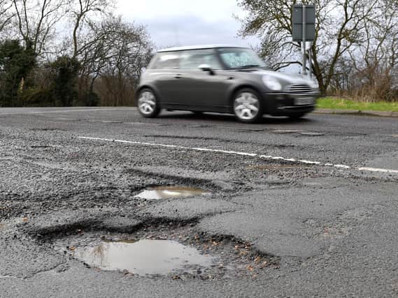 Funding to repair roads in Lancashire cut by a quarter