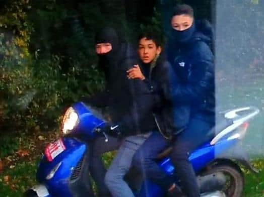 The three boys have been spotted riding a the scooter dangerously and on the wrong side of the road in the Ingol area of Preston. Pic: Lancashire Police
