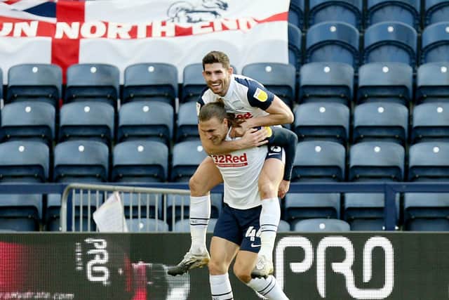 Brad Potts celebrates scoring Preston North End's opening goal against Huddersfield by giving a piggy-back to Ched Evans