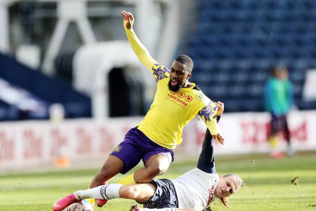 PNE midfielder Brad Potts tackles Hudderfield's Isaac Mbenza