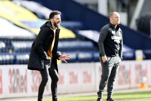 Huddersfield head coach Carlos Corberan and PNE manager Alex Neil watch the action at Deepdale