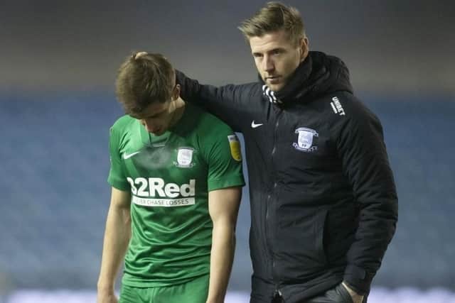 Preston North End midfielder Jayson Molumby is consoled by Paul Gallagher after the defeat at Millwall