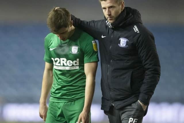 Preston North End's Jayson Molumby is consoled by player-coach Paul Gallagher at the end of the game against Millwall