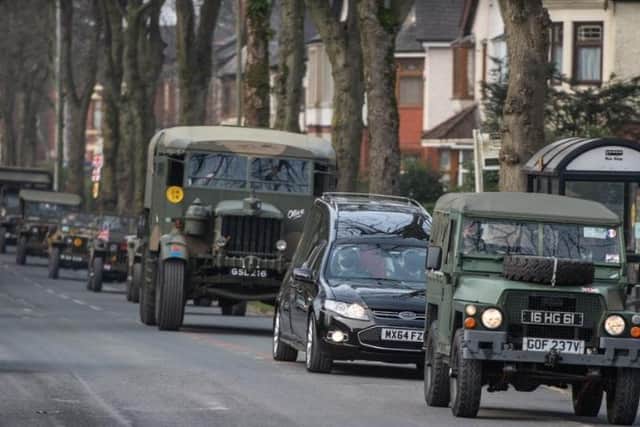 Cyril's cortege is given an escort of old Army vehicles.