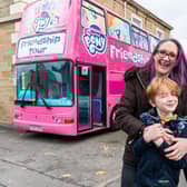 Kerry Driver with her children Leah (12) and Tyler (six) and the big pink double decker bus.