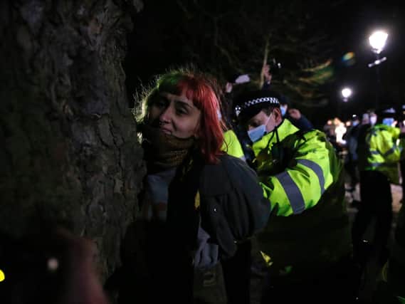 A woman is arrested during a vigil for Sarah Everard on Clapham Common on March 13, 2021 in London